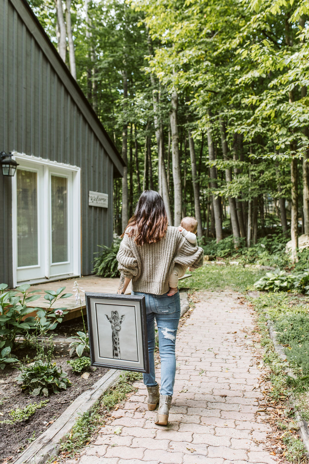 artist walking with her child and an original artwork