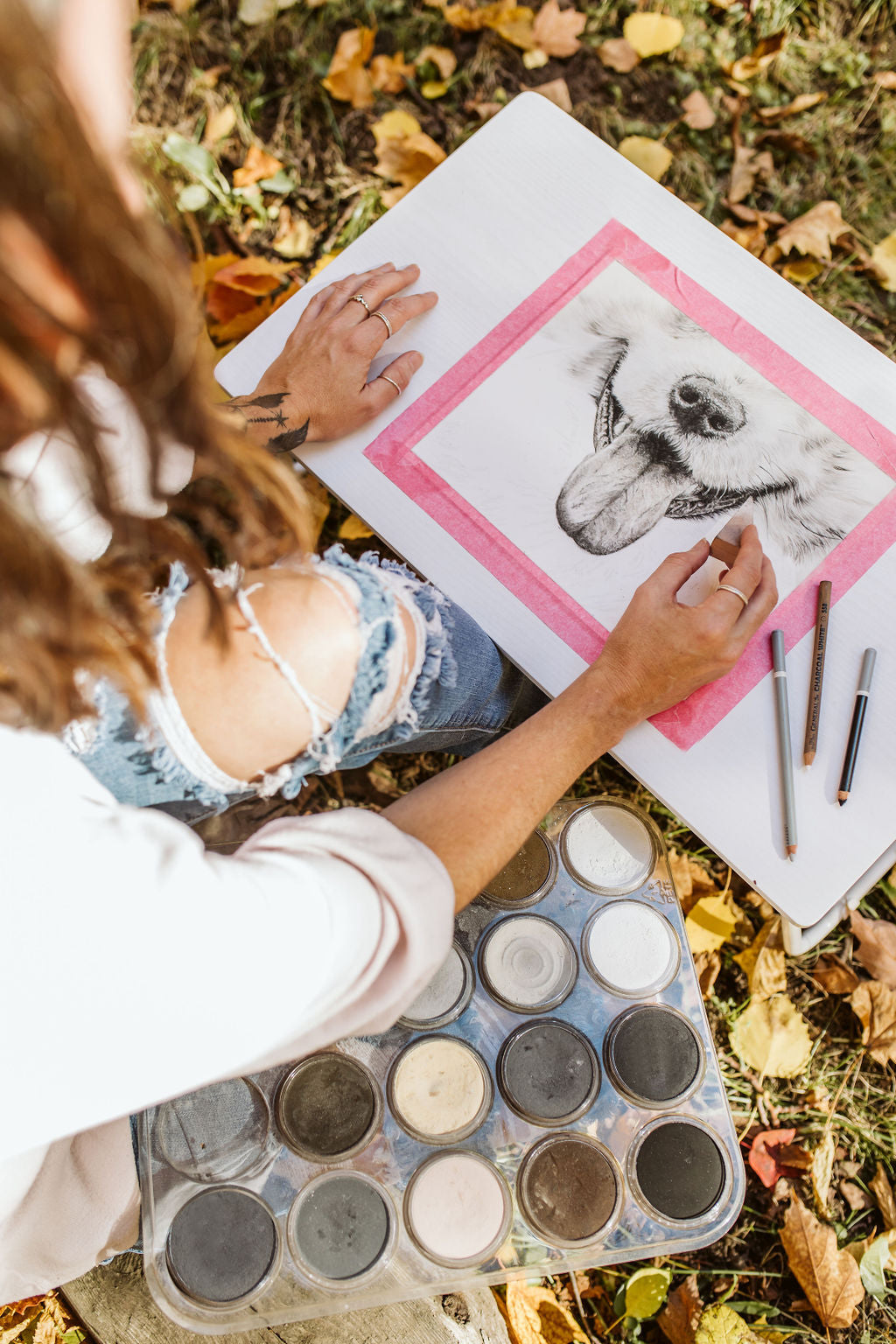 Artist working on her pastel dog artwork