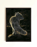 A framed canvas art print depicting a fox standing on a dark background, illuminated by a warm golden glow. The print is housed in a simple black frame and hangs on a plain off-white wall.