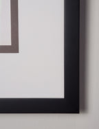 Close-up of a black picture frame corner on a light gray background