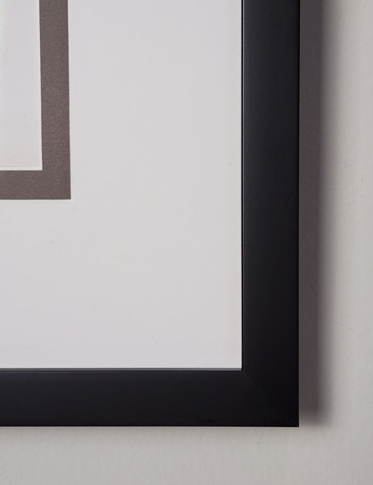 Close-up of a black picture frame corner on a light gray background