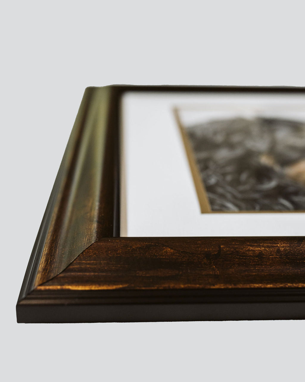 Framed artwork with a dark wood border on a light gray background