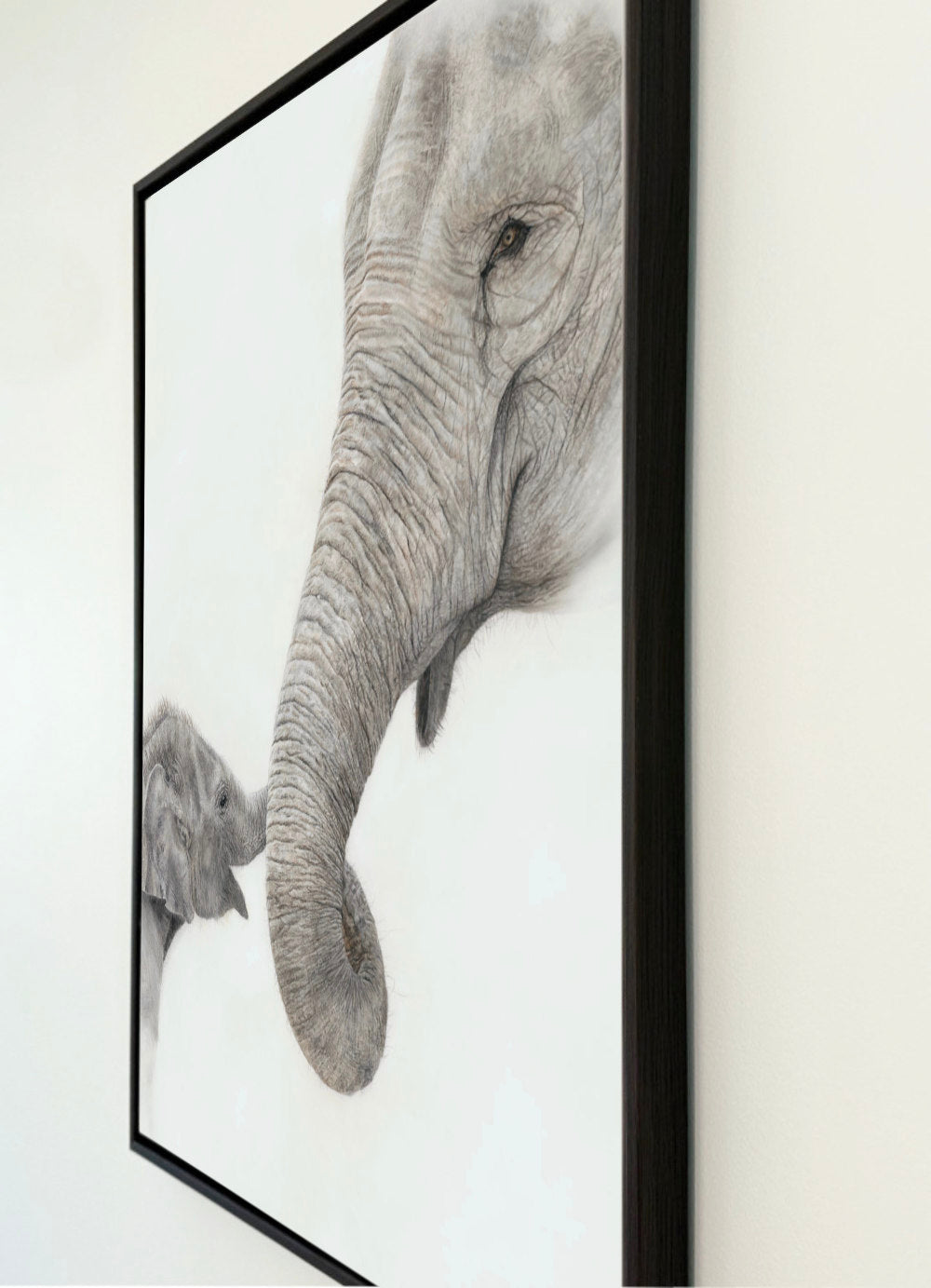 Canvas print featuring a drawing by Crystal Clarke of an elephant mom and calf holding trunks