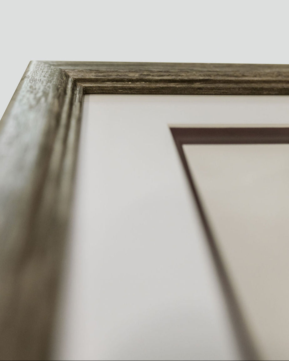 Close-up of a wooden picture frame on a white background