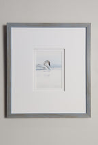 Framed artwork of a swan on a light gray wall