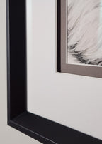 Framed artwork with a black contemporary frame, double matted with a spacer, hung on a white wall
