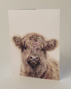 Greeting card with a highland cow illustration on a white background
