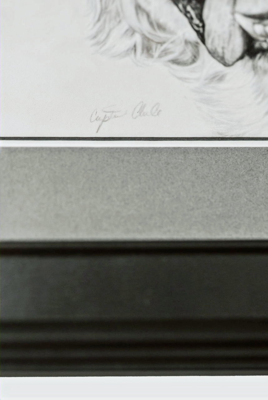 Framed black and white portrait with a signature at the top