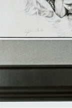 Framed black and white portrait with a signature at the top