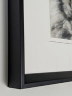 Close-up of a black-framed picture on a light gray background