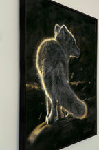 A framed vertical art print depicting a fox standing in profile against a dark, glowing background, mounted on a light wall drawn by Crystal Clarke