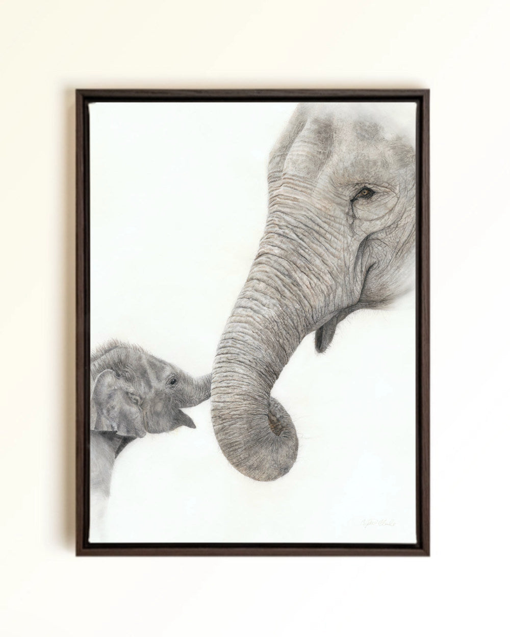 A framed canvas print showing a large elephant and a baby elephant touching trunks, mounted against a light beige wall. Drawing by Crystal Clarke