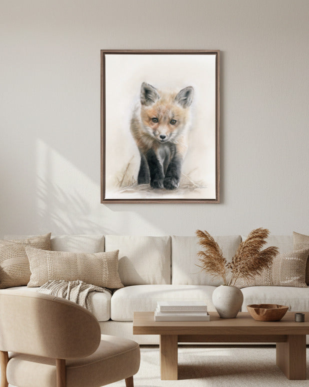 Framed artwork of a fox on a wall above a sofa in a living room.