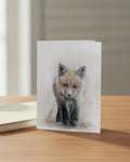 Greeting card with a drawing of a fox on a wooden surface