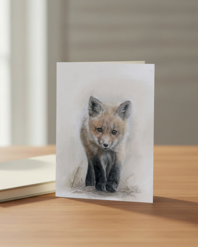 Greeting card with a drawing of a fox on a wooden surface