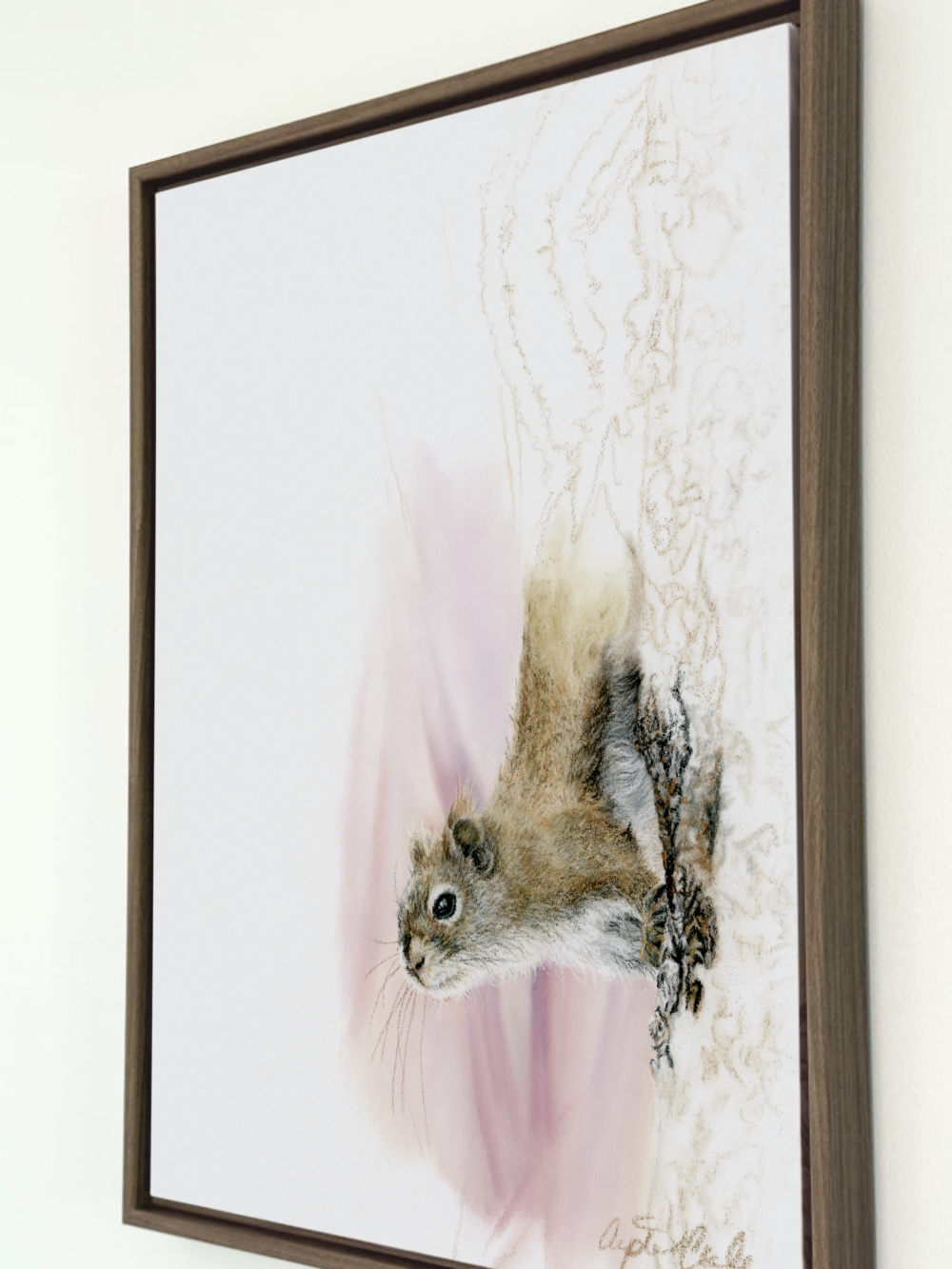 A framed art print featuring a detailed pastel drawing of a squirrel on a white background with soft pink and beige sketch-like accents, enclosed in a warm brown wooden frame.