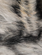 Close-up of a textured pastel drawing of with gray, black, and beige colors.